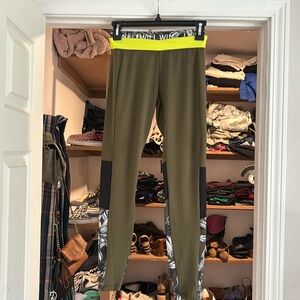 Small army green leggings with neon waistband and flower print on the bottom